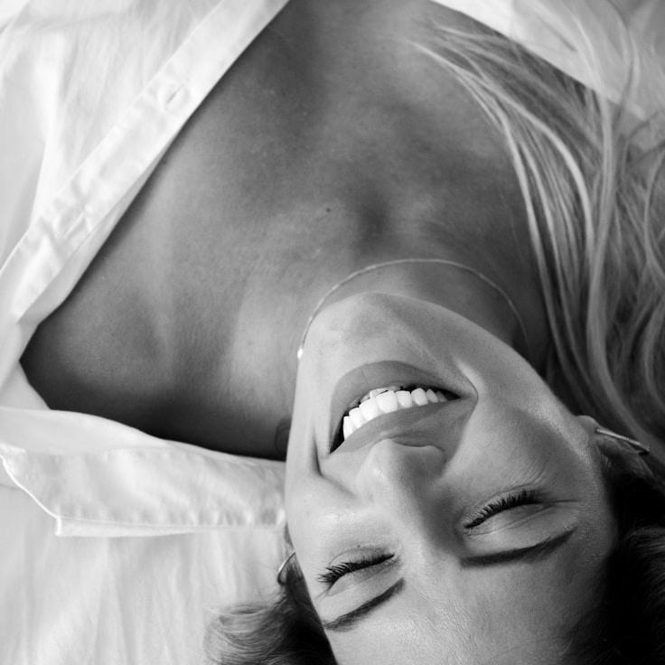 Alex Doe, Lead Design Curator at Silent River Network, reviewing corporate floral arrangements